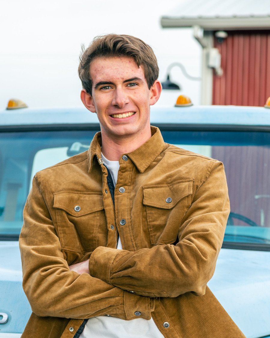 Aidan Goldman standing in front of a vintage Ford pickup truck